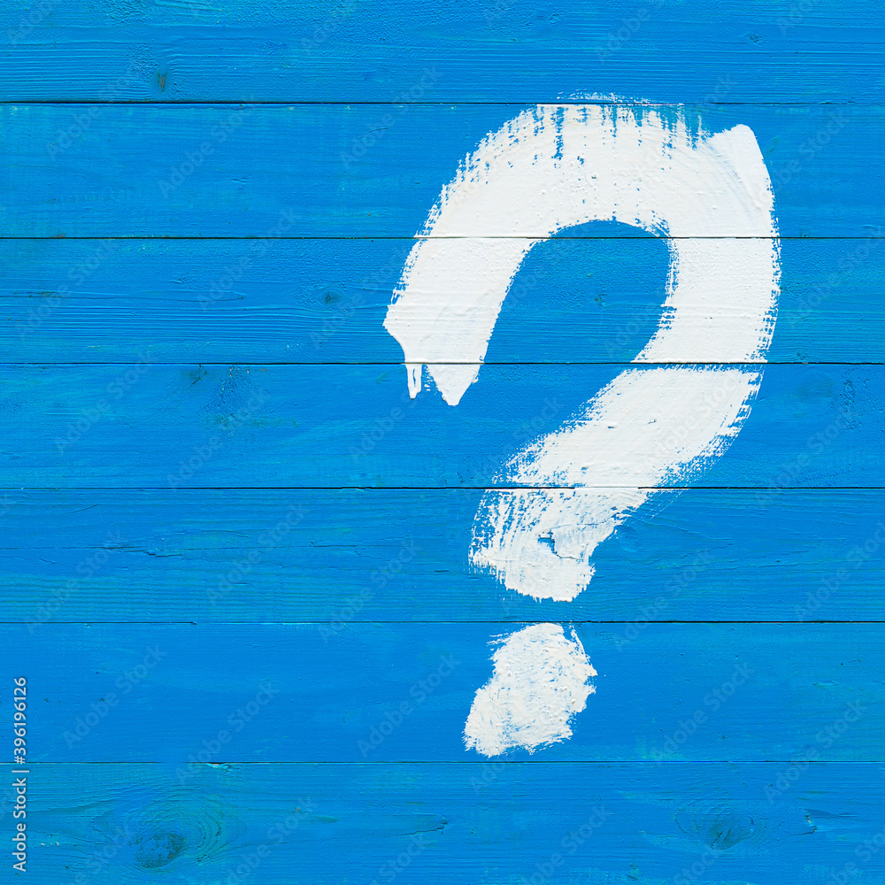 Question mark drawn with a white paint brush on a blue wooden plank