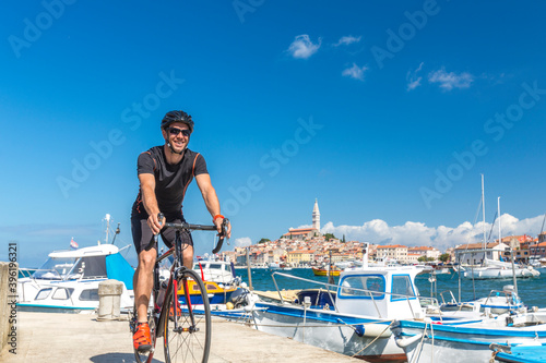 Croatia, Istria, Rovinj, portrait of male cyclist against cityscape © mmphoto