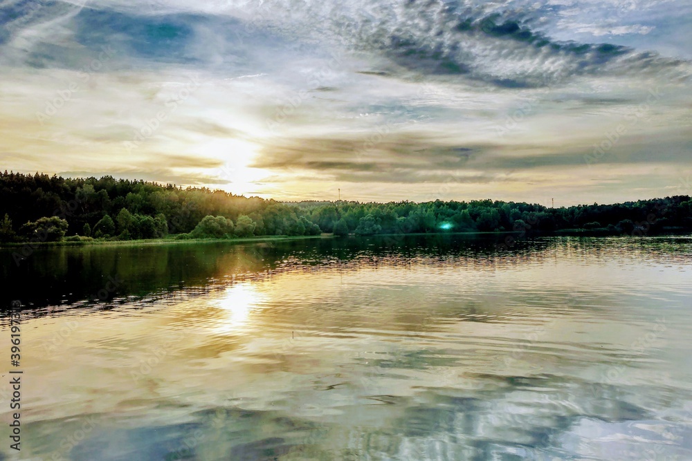 Beautiful sunset on the lake or river. Nature background.