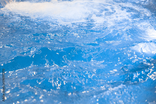 Abstract background blue water in the pool, lots of bubbles in the water