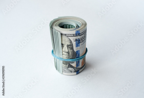 Dollars rolled into a tube on a white background