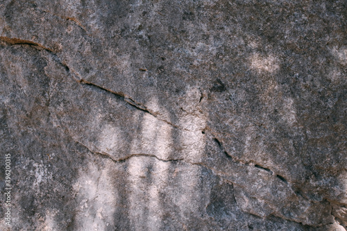 The texture of a large stone, part of a rock on a sunny day. Close-up. Macro