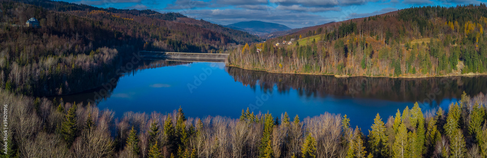 Aerial view of Zapora Wisla Czarne, water dam in Poland close to city of Wisla, with big accumulation lake behind the dam in late autumn.