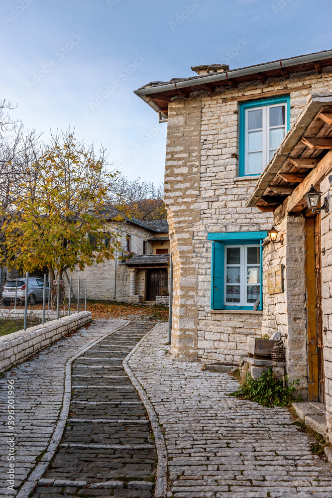 Traditional architecture with  narrow  street and stone buildings a in Monodendri village  central Zagori Greece