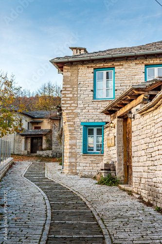 Fototapeta Naklejka Na Ścianę i Meble -  Traditional architecture with  narrow  street and stone buildings a in Monodendri village  central Zagori Greece