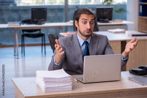 Young male employee working in the office