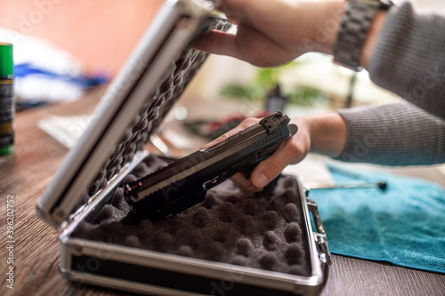 Ταπετσαρία Man putting gun in safe box