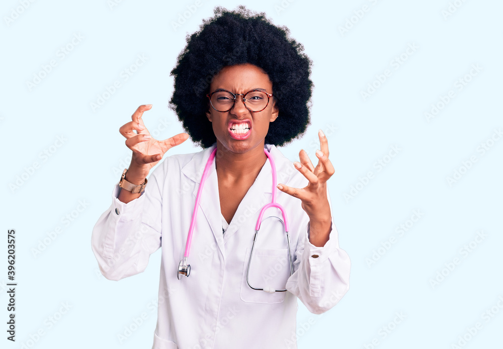 Young african american woman wearing doctor coat and stethoscope shouting frustrated with rage, hands trying to strangle, yelling mad Young african american woman wearing doctor coat and stethoscope shouting frustrated with rage, hands trying to strangle, yelling mad