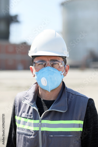 The worker is using protective mask and safety glasses to protect coronavirus (covid-19) pandemic. Masks are also strongly recommended for those who may have been infected and those taking care.
