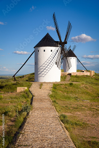 Exterior view of windmills on landscape in spring in Alcazar de San Juan, Ciudad Real, Spain