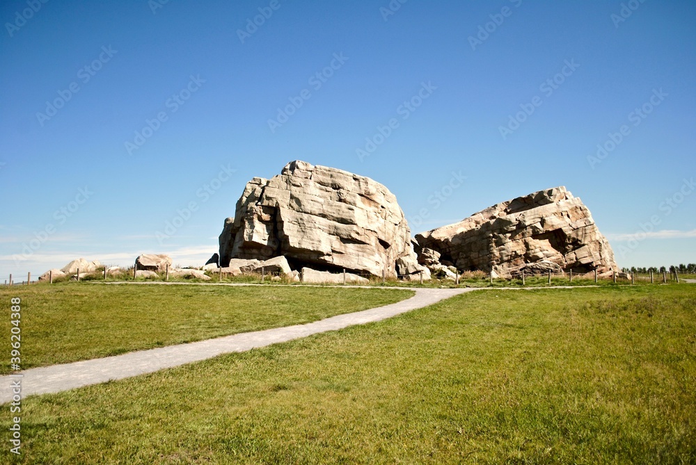 Big Rock Erratic. This massive and unusual rock formation near Okotoks, Alberta, Canada is the world's largest glacial erratic. Large chunks of rock left by ice age glaciers on otherwise flat ground. 