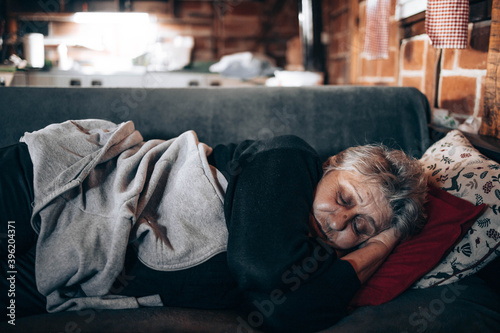 Elderly woman sleeping on a couch in the living room