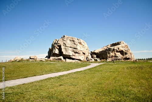 Big Rock Erratic. This massive and unusual rock formation near Okotoks, Alberta, Canada is the world's largest glacial erratic. Large chunks of rock left by ice age glaciers on otherwise flat ground.  photo