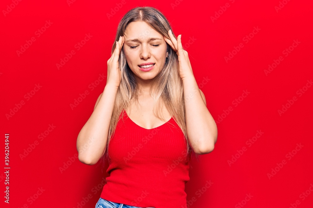 Young blonde woman wearing casual clothes with hand on head for pain in head because stress. suffering migraine. Young blonde woman wearing casual clothes with hand on head for pain in head because stress. suffering migraine.