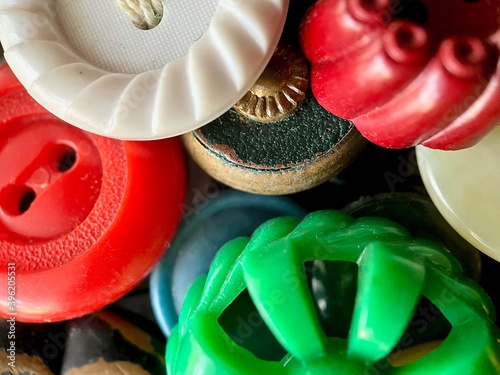 Multi-colored antique or vintage sewing buttons: Celluloid Buttons, Bakelite Buttons, Lucite Buttons, vegetable Ivory, metal, China, glass, and mother of pearl. 