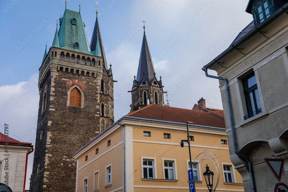 Medieval stone St. Bartholomew´s Church with belfry tower, Gothic Cathedral at the end of narrow street in autumn day, arched windows, Kolin, Central Bohemia, Czech republic