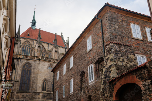 Medieval stone St. Bartholomew´s Church, Gothic Cathedral at the end of narrow street in autumn day, arched windows, chimeras and gargoyles, Kolin, Central Bohemia, Czech republic
