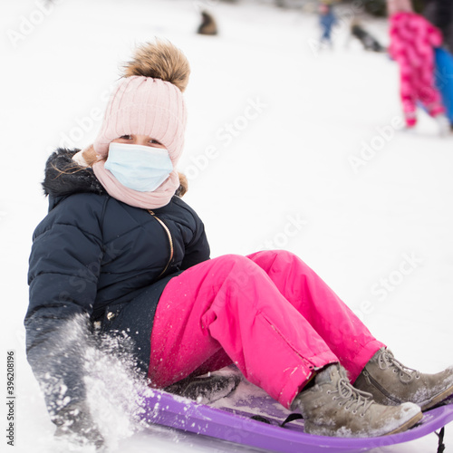 Petite fille sur traîneau avec masque respiratoire