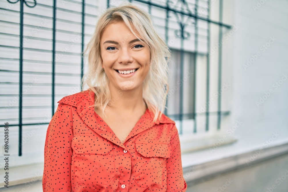 Young blonde woman smiling happy walking at the city. Young blonde woman smiling happy walking at the city.