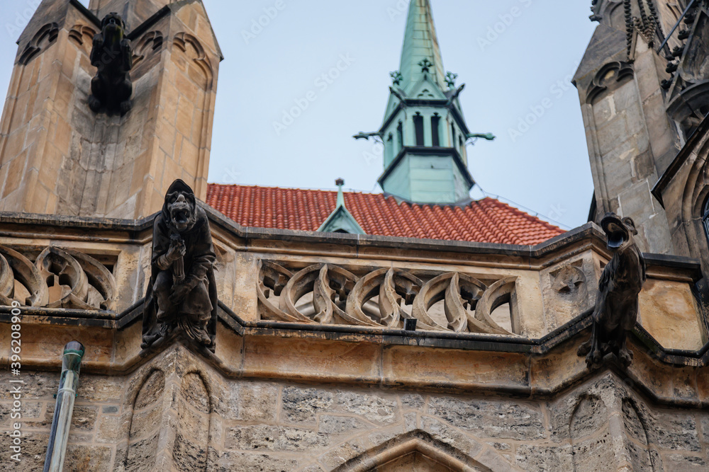 Low angle view at a part of Medieval stone St. Bartholomew´s Church in autumn day, arched windows, chimeras and gargoyles, Gothic Cathedral, Kolin, Central Bohemia, Czech republic