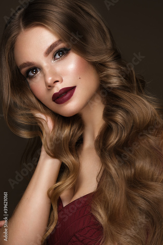 Beautiful sexy woman with classic make-up, fashion hair and red lips. Beauty face. Photo taken in the studio.