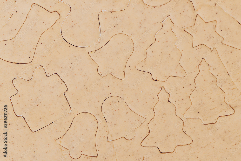 Gingerbread aromatic and spiced dough for Christmas cookie in different shapes prepared for baking, top view. Gingerbread aromatic and spiced dough for Christmas cookie in different shapes prepared for baking, top view.