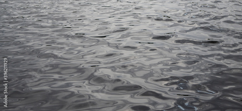 Grey water texture in the lake. © Igor
