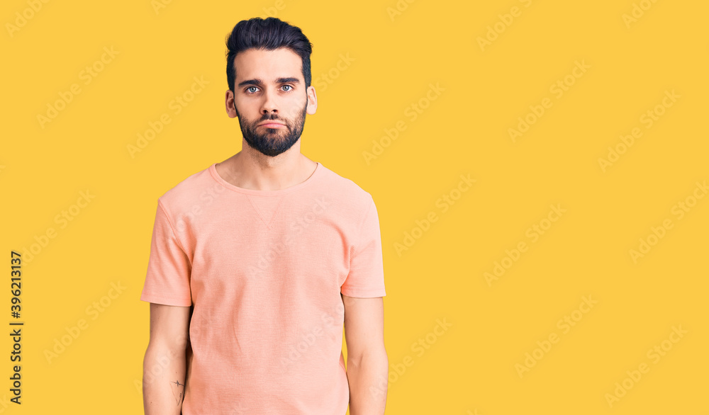 Young handsome man with beard wearing casual t-shirt depressed and worry for distress, crying angry and afraid. sad expression. Young handsome man with beard wearing casual t-shirt depressed and worry for distress, crying angry and afraid. sad expression.