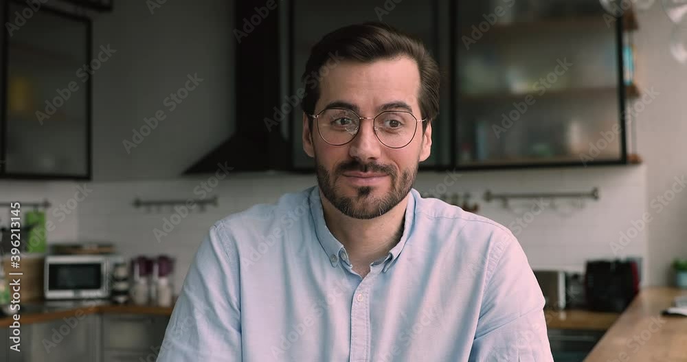 Due corona virus and lockdown, business negotiation conduct from home using video call app concept. Head shot portrait businessman sit in home kitchen talk to client of friend remotely use videocall