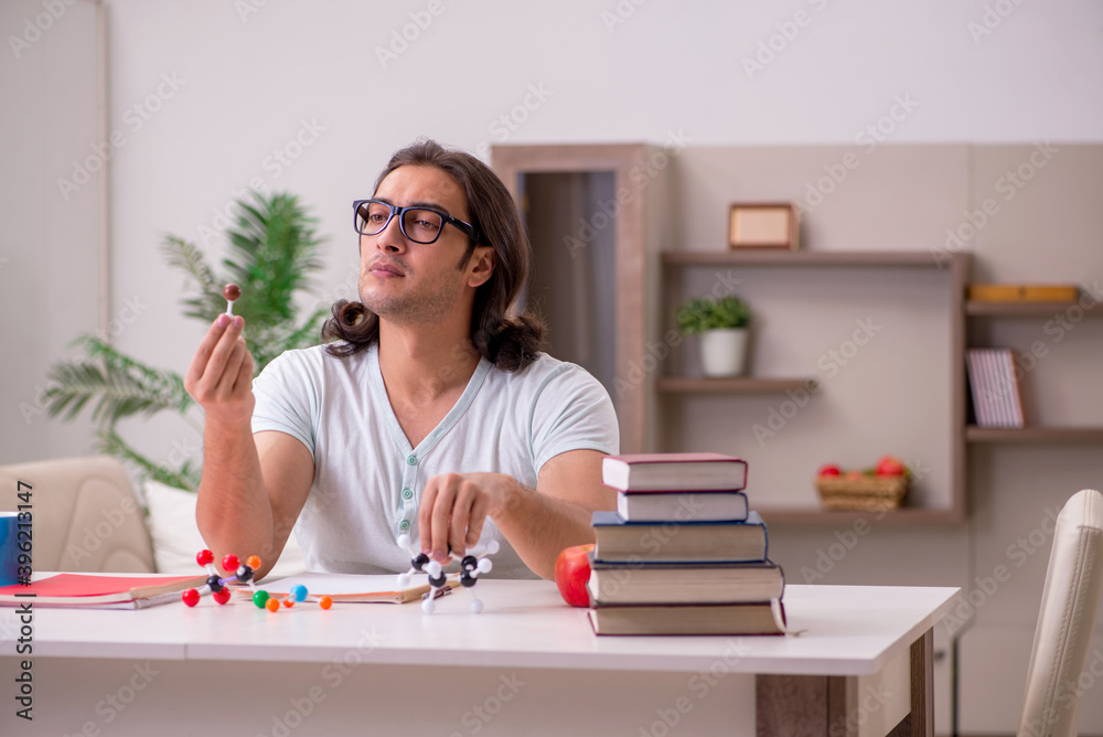 Young male student preparing for exams at home Young male student preparing for exams at home