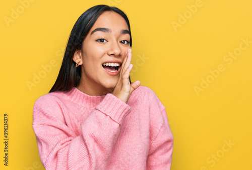 Fotografie Young asian woman wearing casual winter sweater hand on mouth telling secret rum