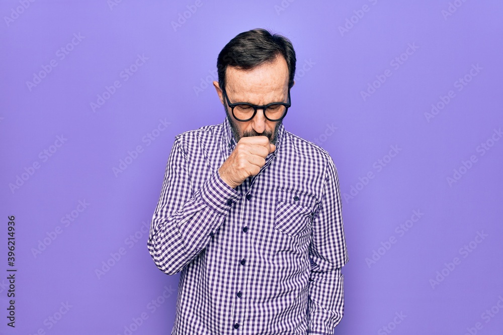 Middle age handsome man wearing casual shirt and glasses over isolated white background feeling unwell and coughing as symptom for cold or bronchitis. Health care concept.