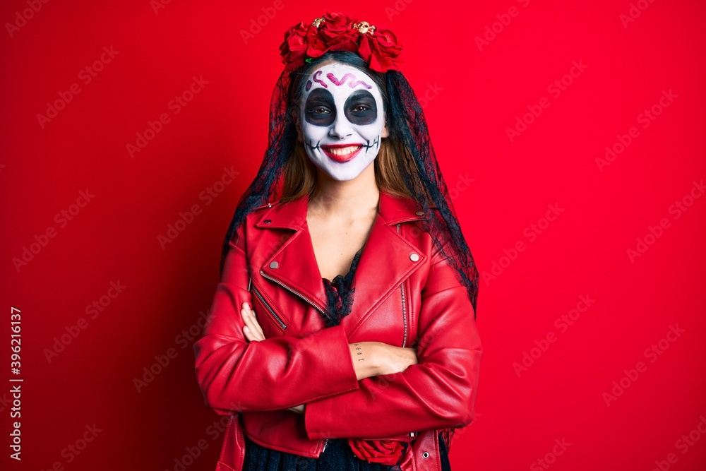 Woman wearing day of the dead costume over red happy face smiling with crossed arms looking at the camera. positive person. Woman wearing day of the dead costume over red happy face smiling with crossed arms looking at the camera. positive person.