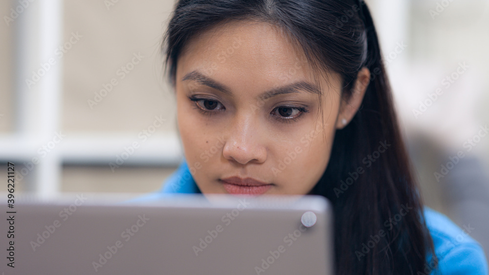 Young woman works with a tablet computer - home shooting Young woman works with a tablet computer - home shooting
