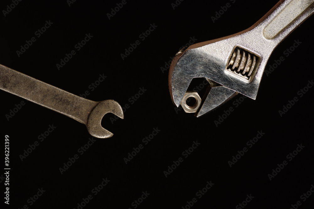 Carob wrench as it passes the nut to another carob wrench Carob wrench as it passes the nut to another carob wrench