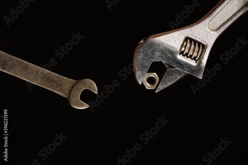 Carob wrench as it passes the nut to another carob wrench