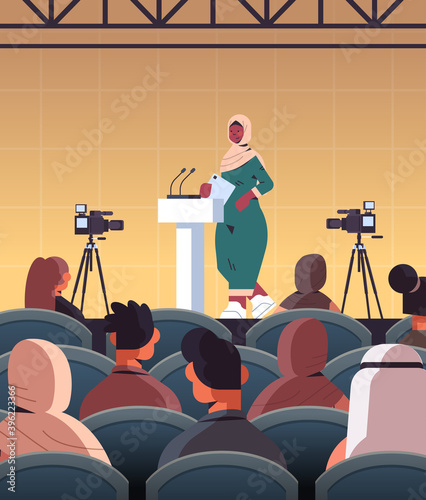 arab female doctor giving speech at tribune with microphone medical conference meeting medicine healthcare concept lecture hall interior vertical vector illustration