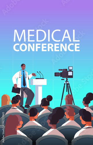 african american male doctor giving speech at tribune with microphone medical conference medicine healthcare concept lecture hall interior vertical vector illustration