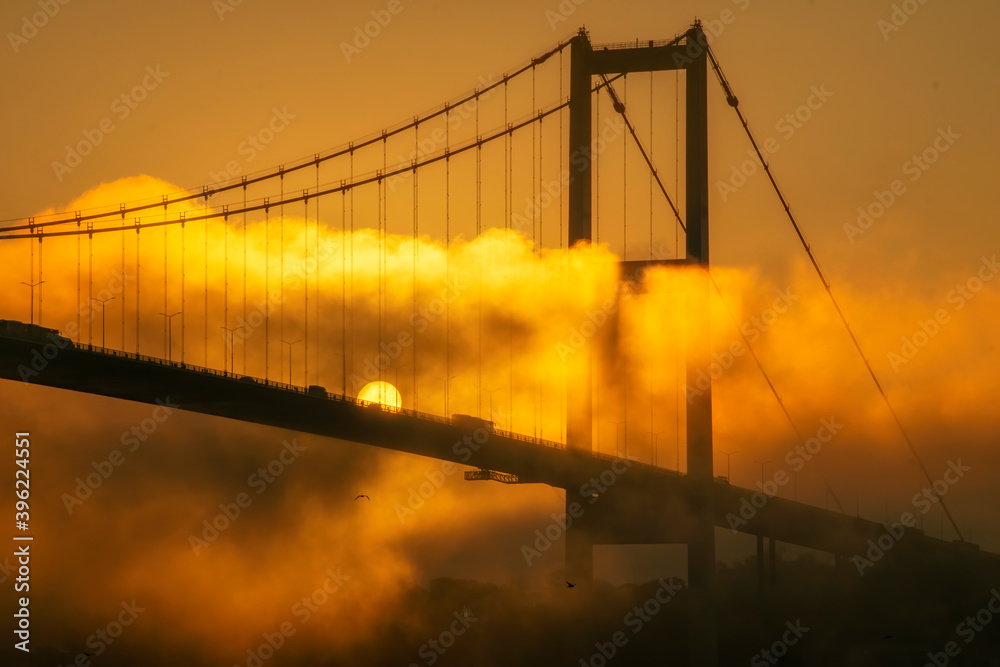 Fototapeta premium Foggy and Misty scene of Bosphorus Bridge. Bridge over the Bosphorus in Istanbul. View from the Asian part of Istanbul. The 15 July Martyrs Bridge in a fog