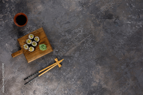 Appetizing rolls on a textured background. Japanese food concept. Close-up. Copy space. Flat lay.