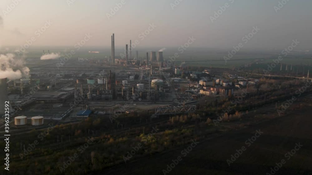 Polluting factory at dawn.Climate change and Industrial climate change.Oil Refinery in Romania,Europe. Polluting factory at dawn.Climate change and Industrial climate change.Oil Refinery in Romania,Europe.
