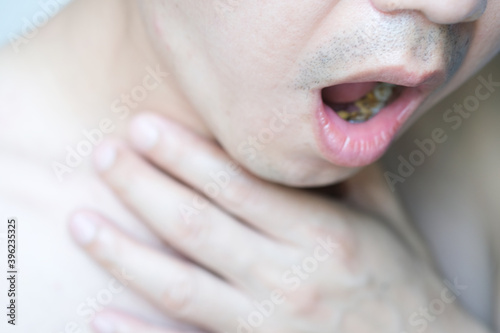 Men with cough, men with acid reflux disease Nausea vomiting on white background health and Medical concept.soft focus photo