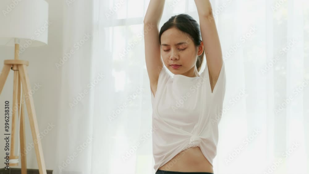 young Asian women doing yoga exercises in the living room at home. young Asian women doing yoga exercises in the living room at home.