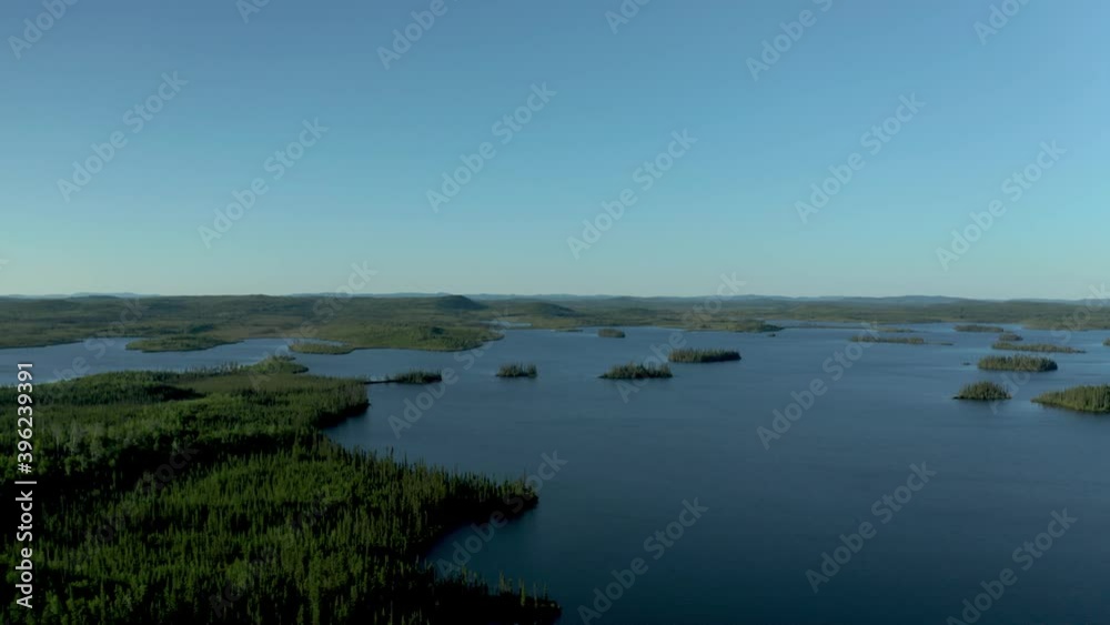 Drone flying over a beautiful and wild lake and forest on a sunny summer day Drone flying over a beautiful and wild lake and forest on a sunny summer day