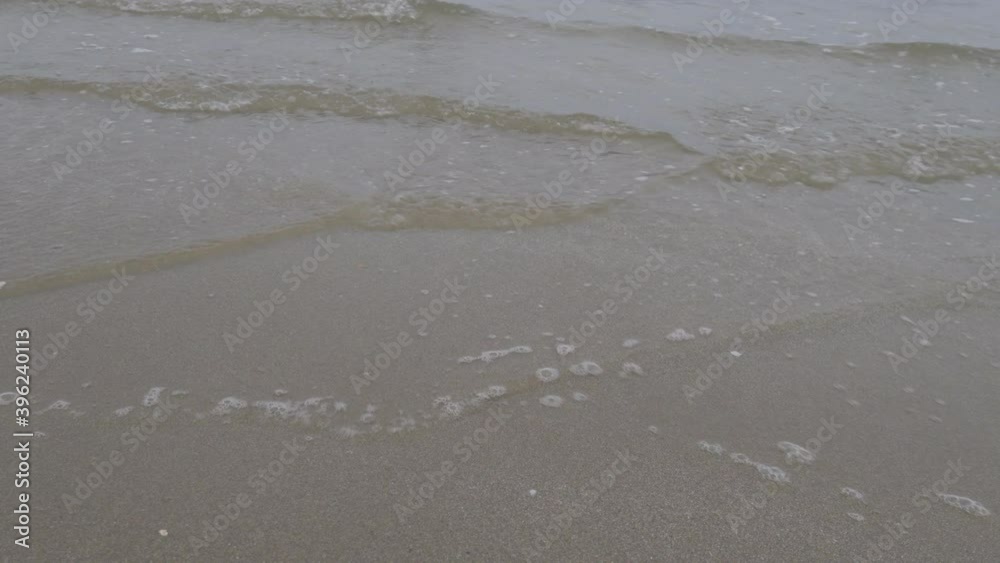 4K Video Close up ocean wave bubble on sandy beach. Background for vacation holiday and natural feeling. 4K Video Close up ocean wave bubble on sandy beach. Background for vacation holiday and natural feeling.