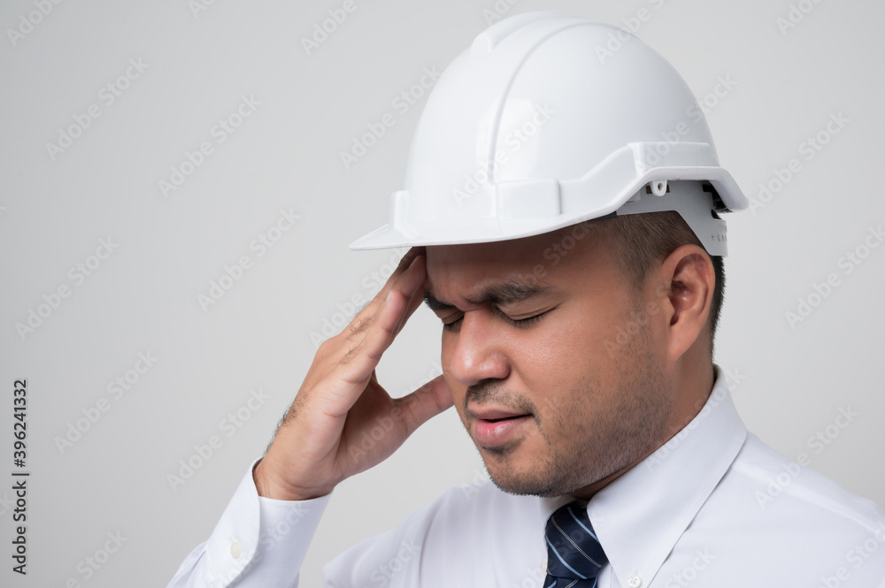 Young asian civil engineer helmet hard hat standing and headache hands rubbing eyes feeling depressed on isolated white background. Mechanic service concept. Young asian civil engineer helmet hard hat standing and headache hands rubbing eyes feeling depressed on isolated white background. Mechanic service concept.