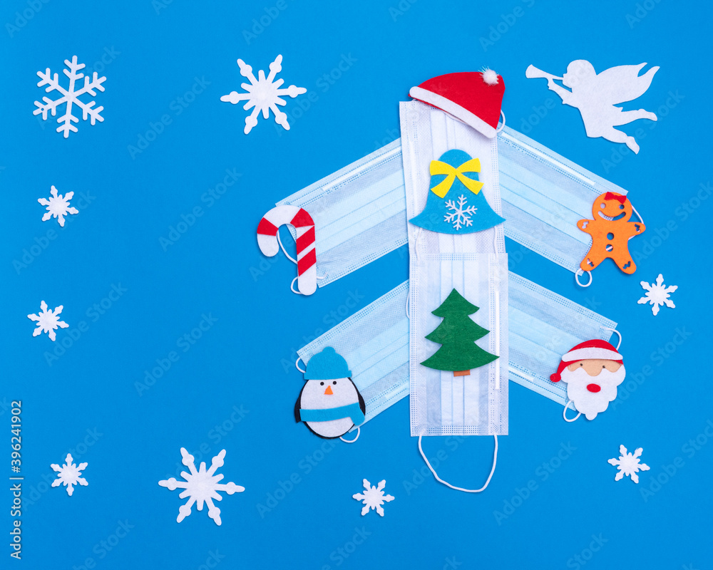 Christmas tree made of medical protective masks, decorated with toys, white angel and snowflakes