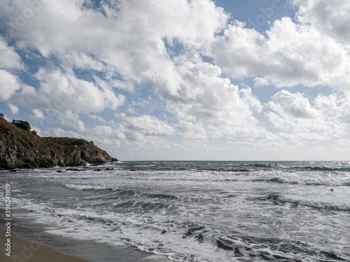 Coast of sea with clouds and sand of beach