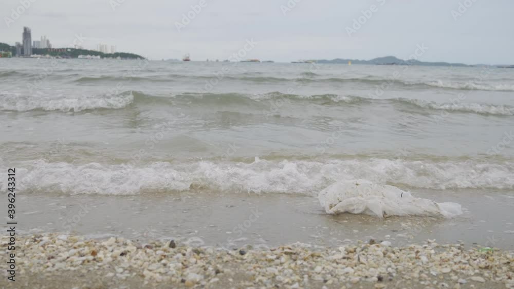 4K Video Plastic bag and garbage on dirty beach. Concept for beach and ocean pollution and environment. 4K Video Plastic bag and garbage on dirty beach. Concept for beach and ocean pollution and environment.