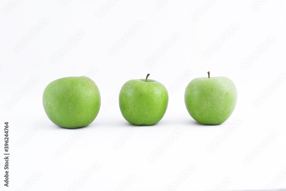 Three fresh sour healthy green apples on a white background Three fresh sour healthy green apples on a white background